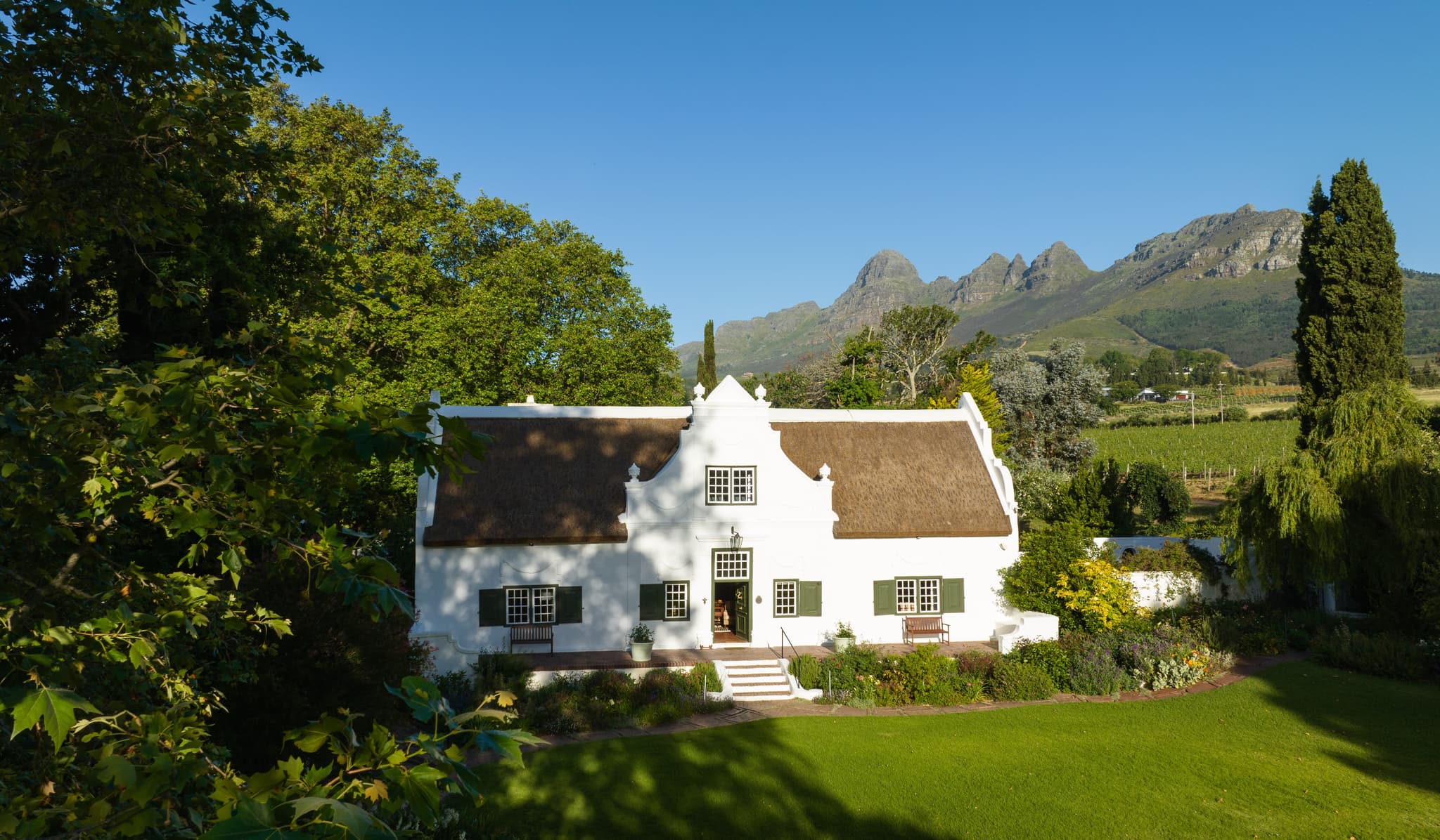 Navarre Residence Cape Dutch manor house with thatched roof and mountains
